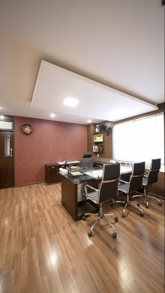 Executive cabin with a glass-top desk and visitor seating