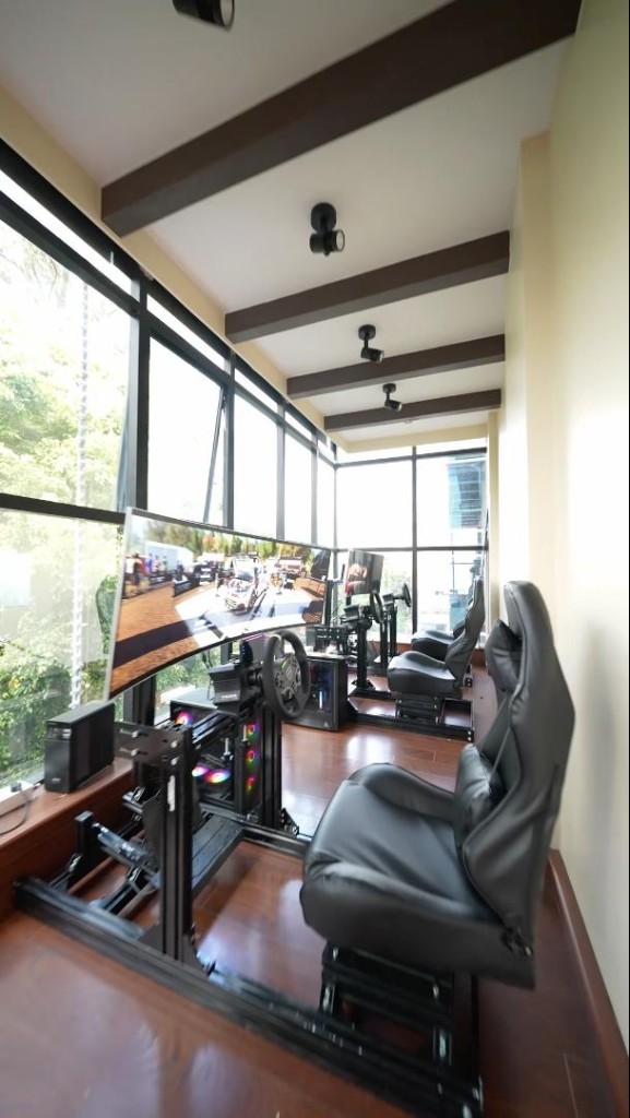 Gaming lounge with racing simulator rigs along the window
